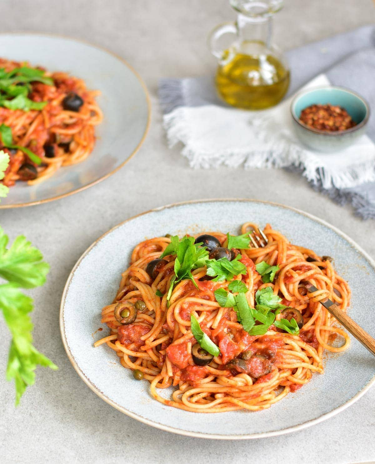 Spaghetti alla puttanesca - tomatoes, olives, capers and anchovies pasta