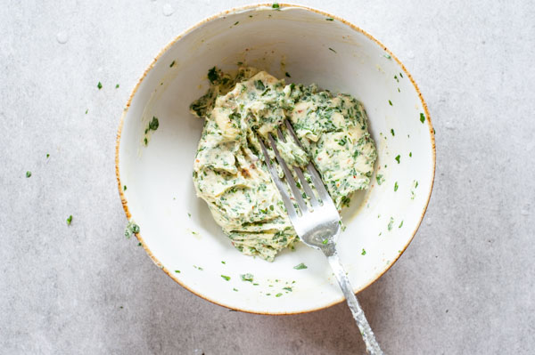 herb and chili butter in a white bowl