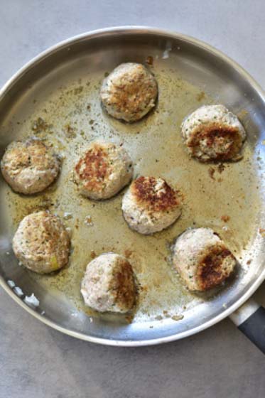 ricotta meatballs are being pan-fried