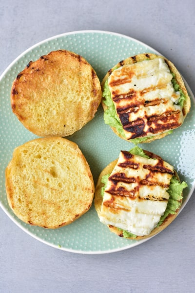 hamburger brioche buns with smashed avocado and grilled halloumi cheese