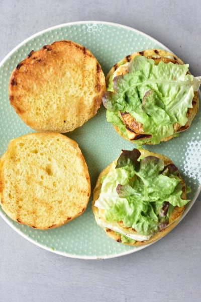 grilled halloumi, pineapple, smashed avocado and salad on hamburger buns