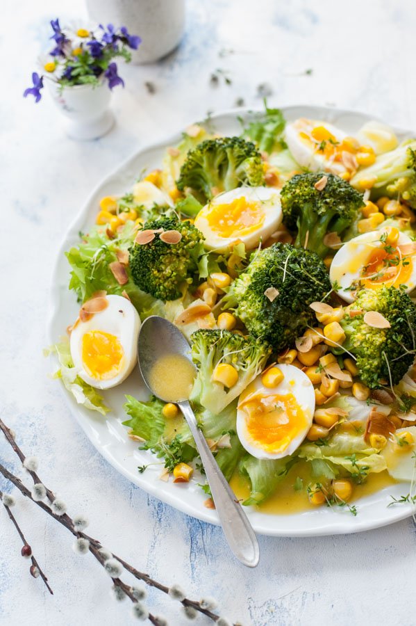 Close up on broccoli egg salad with corn and honey mustard dressing