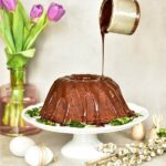 chocolate orange bundt cake on a white cake stand