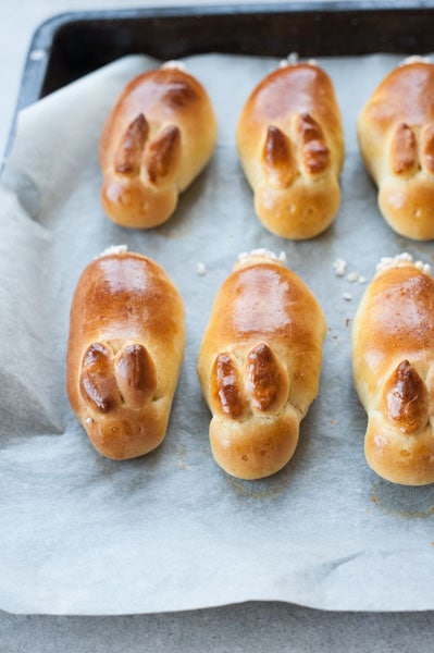 Baked easter bunny rolls on a baking tray lined with baking paper