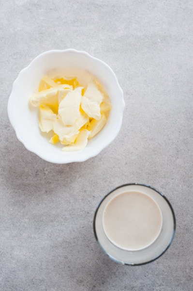 Yeast dissolved in milk, butter in a small bowl