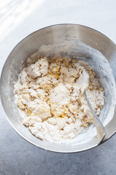 Roughly combined yeast dough ingredients in a metal bowl