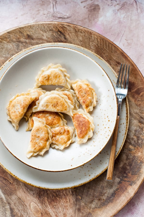 Vegan pierogi with spicy red lentil and sun-dried tomato filling on a plate