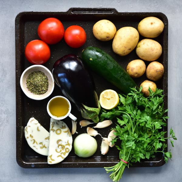 all the vegetables needed to prepare  briami on a black tray