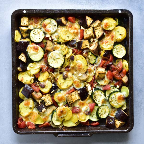 baked briami on a black baking tray