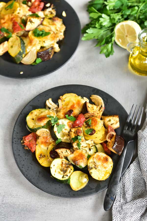 briami greek style oven roasted vegetables on a black plate