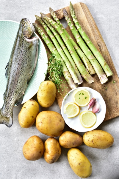 Ingredients needed to prepare whole roasted trout one sheet pan dinner