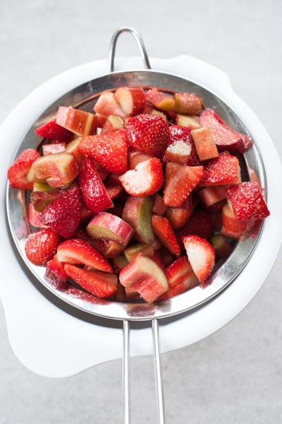 rhubarb and strawberries on a sieve