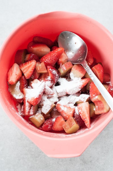 rhubarb, strawberries and cornstarch in a red bowl