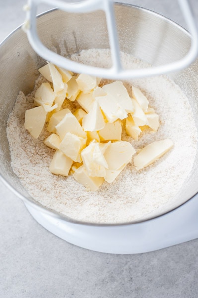 flour mixture and cubbed butter in a mixer bowl