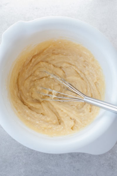 mango muffins batter in a white bowl