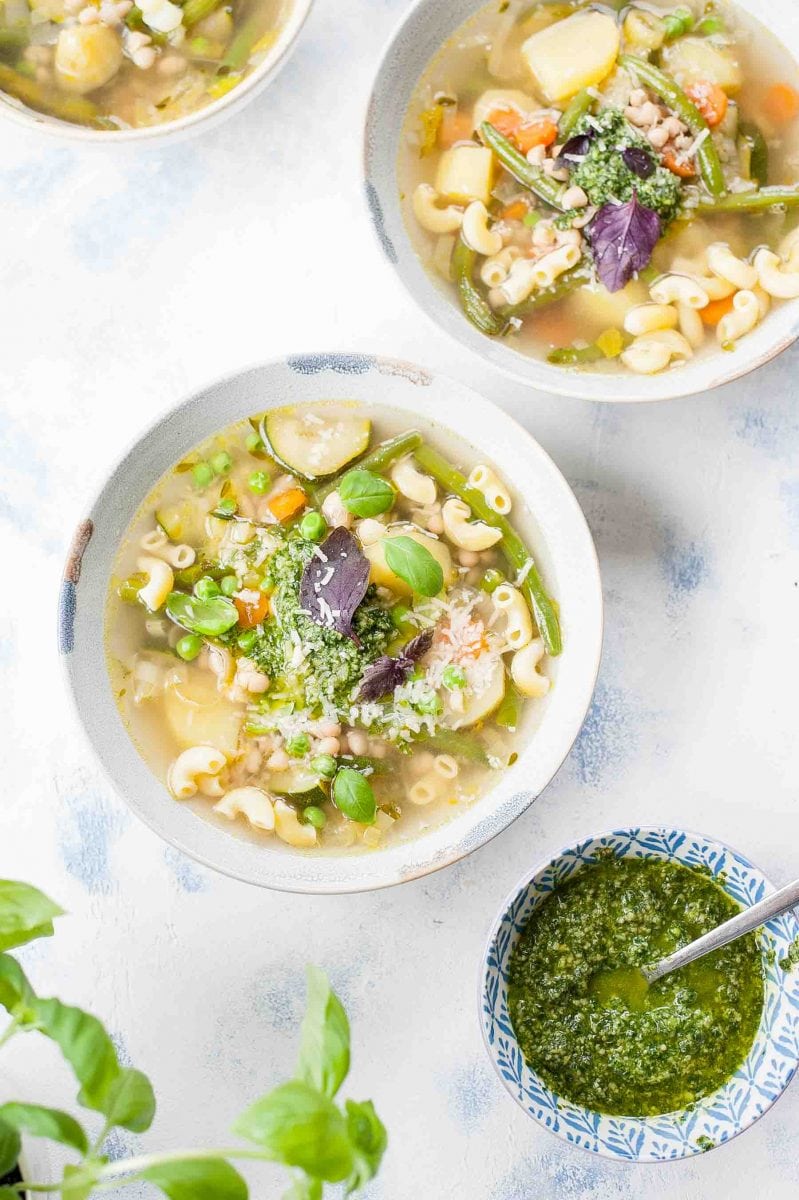 3 bowls with pistou soup and 1 small bowl with pistou