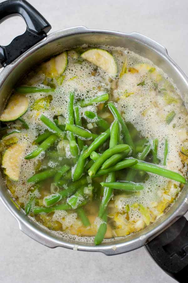 green beans added to the pot with vegetables and water