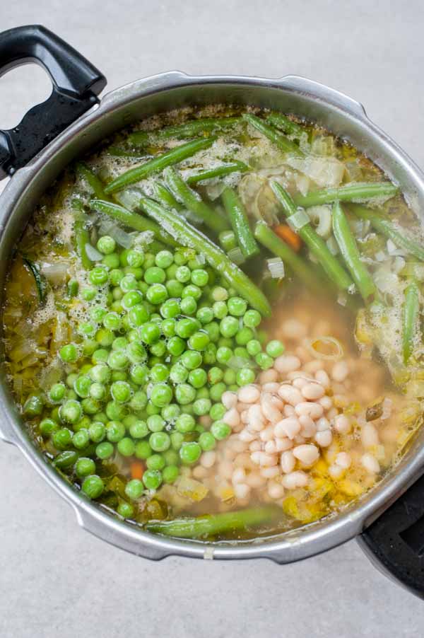 green peas added to the pot with the pistou soup