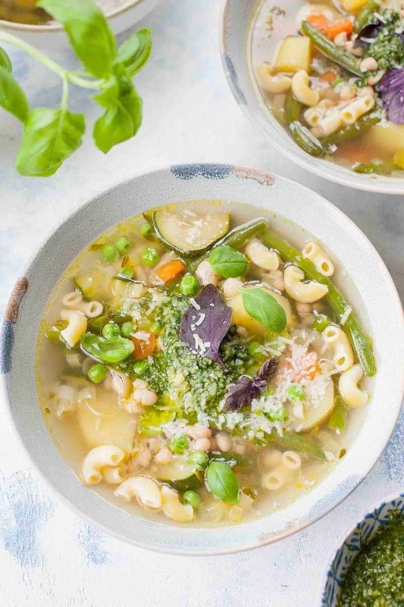 close up shot on a soupe au pistou in a light blue bowl