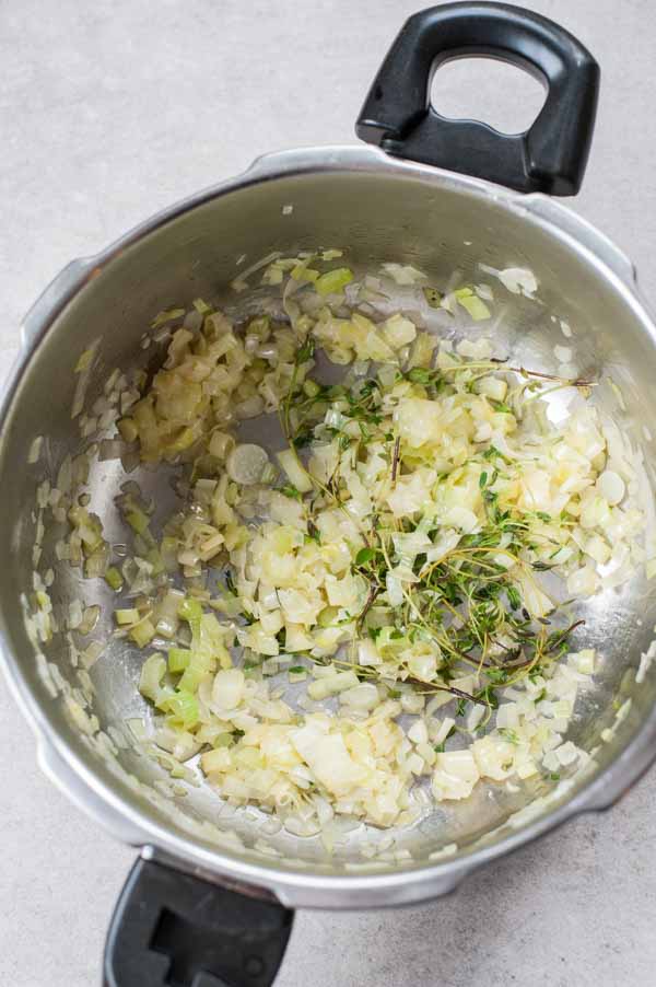sauteed onion, leek and thyme in a pot