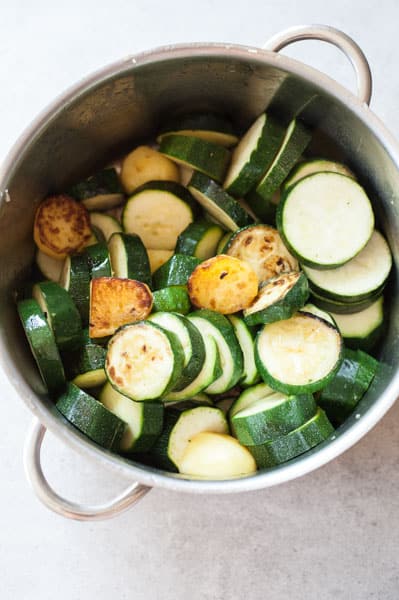 browned zucchini and potatoes in a pot