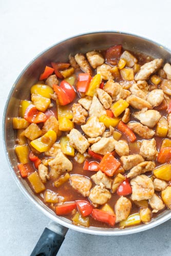 sweet and sour chicken with pineapple on a pan