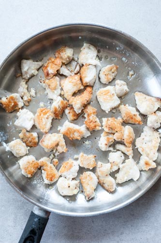 pan-fried chicken breast pieces on a pan