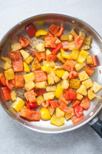 browned pineapple and bell paprika on a pan