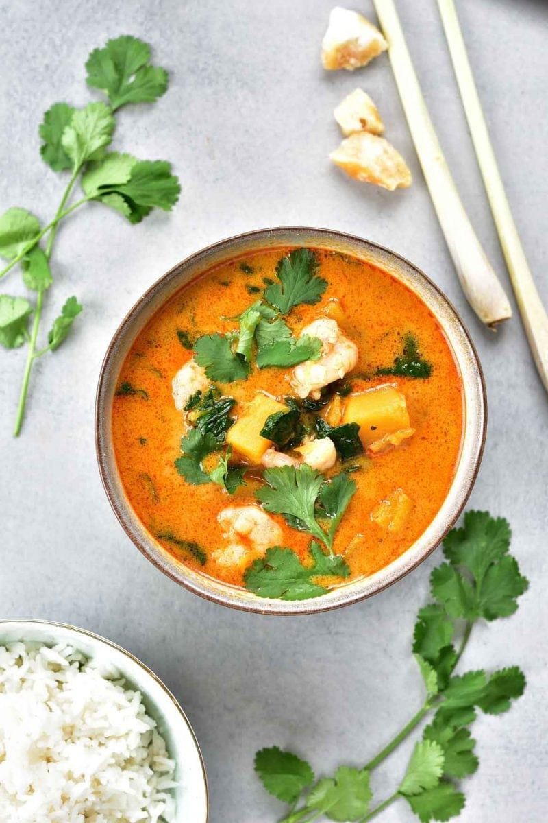 Thai red curry with shrimp, pumpkin, and spinach in a bowl.