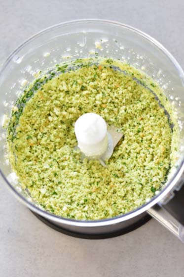 parmezan, kaiser roll and parsley grounded in a food processor bowl