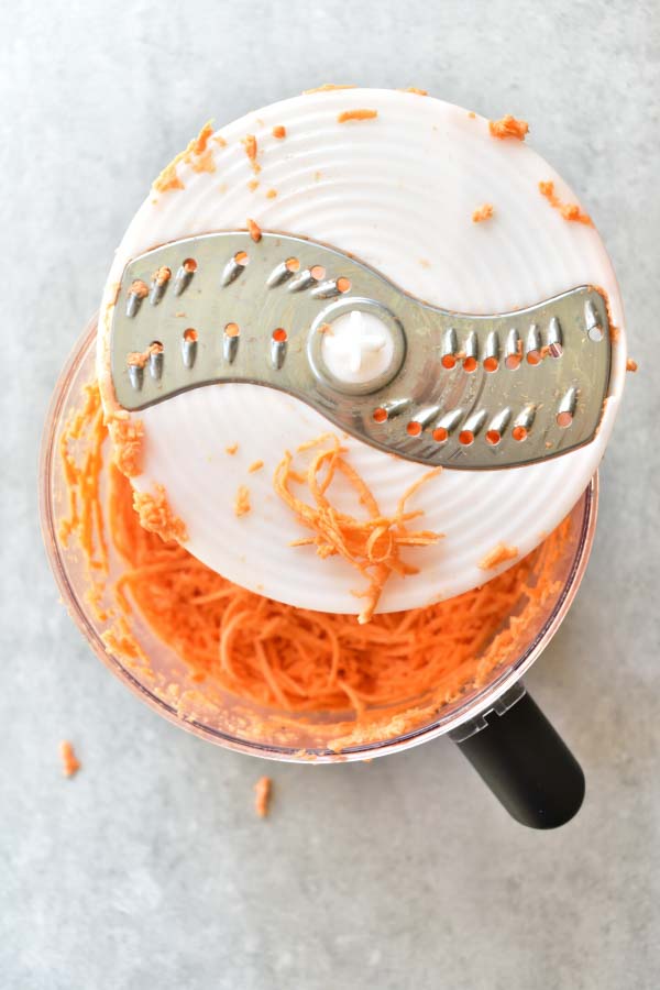 grated sweet potato in a food processor bowl