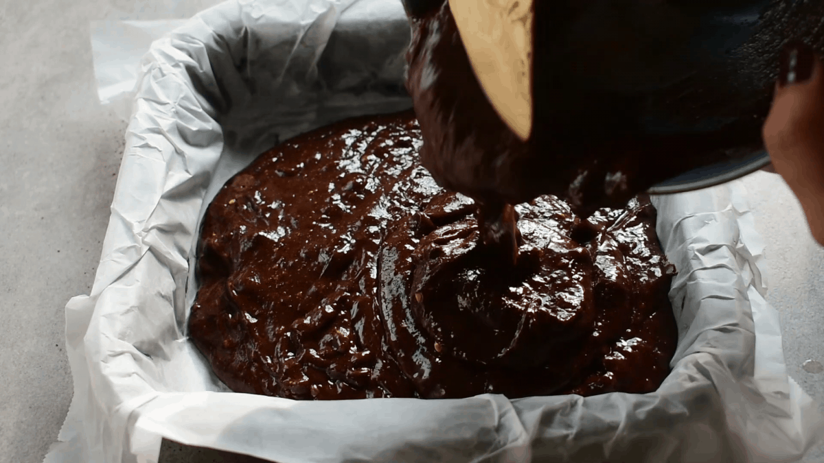 batter is being poured into a pan