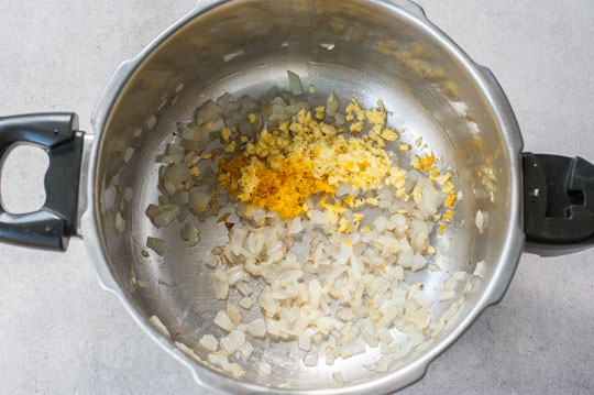 sauteed onion, grated ginger and orange zest in a pot