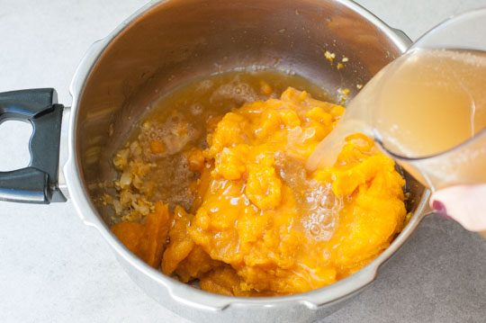 broth is being poured into a pot