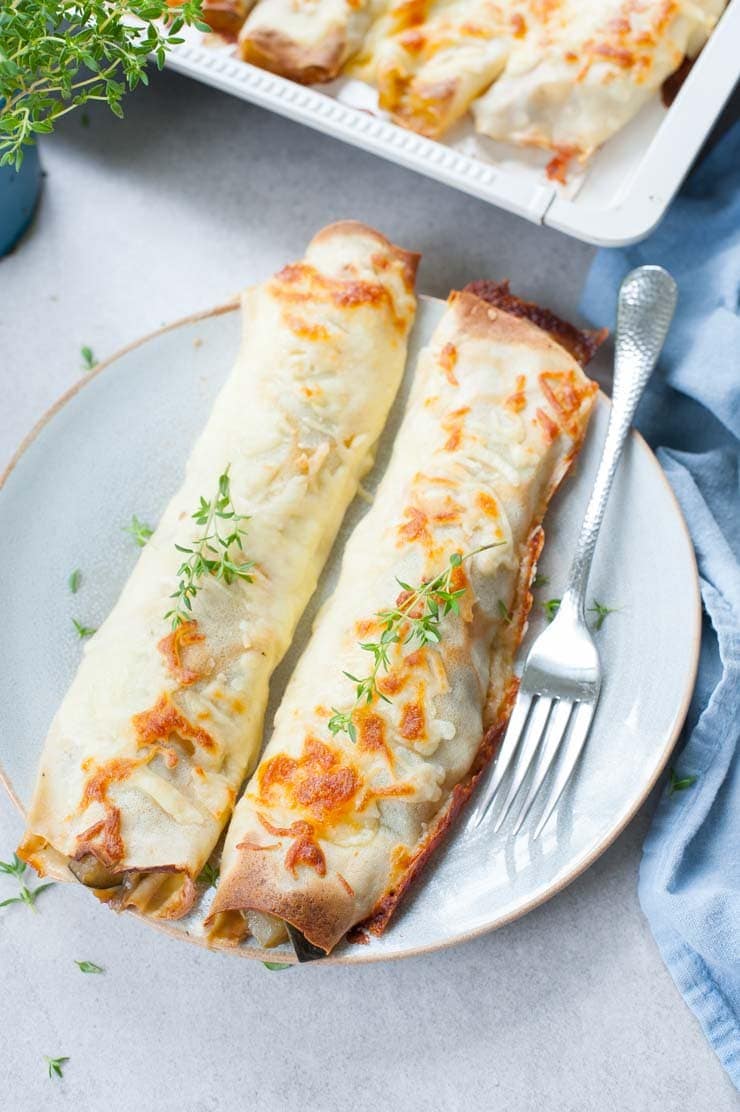 Cheesy vegetable crepes on a blue plate