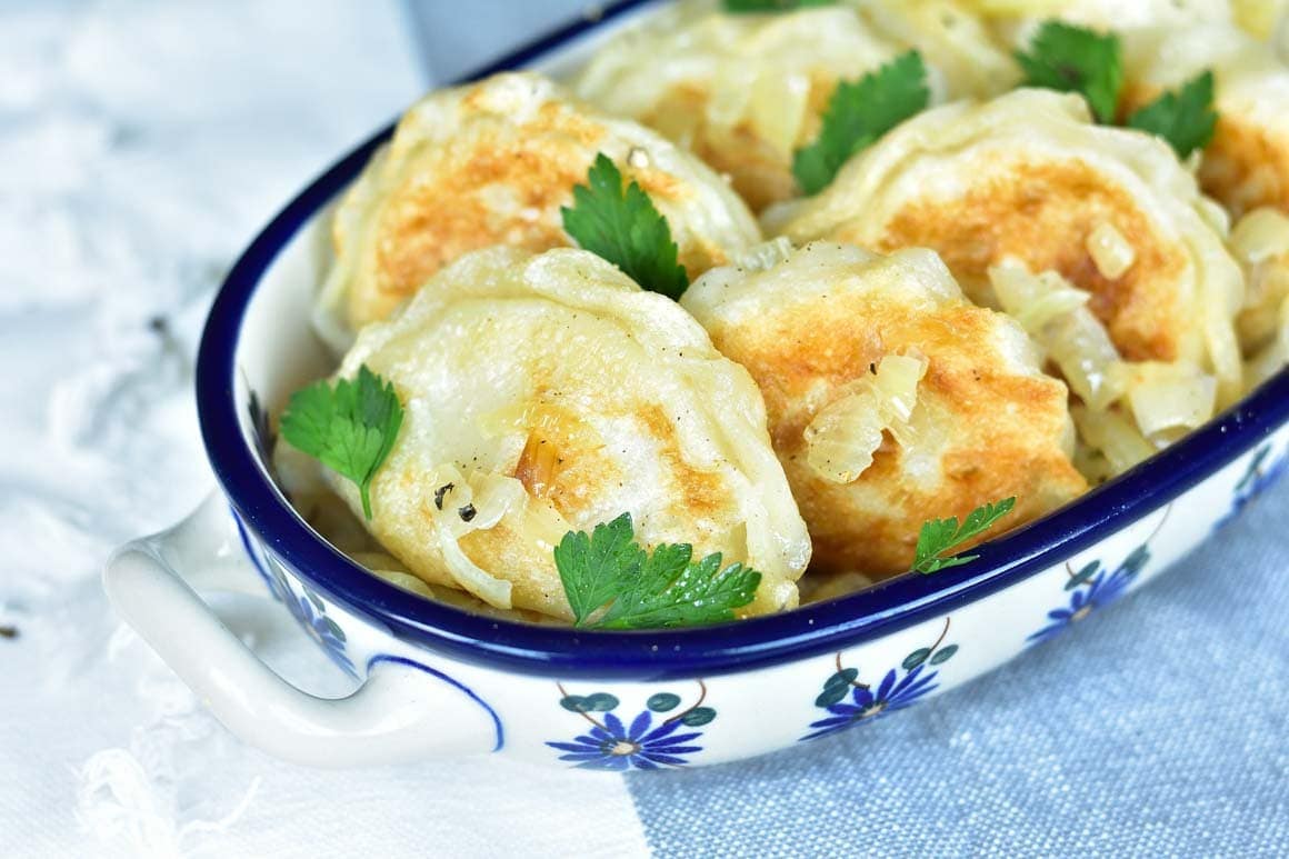 Pierogi ruskie in a white-blue bowl.