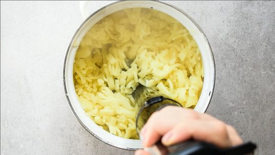 potatoes are being mashed with an immersion blender