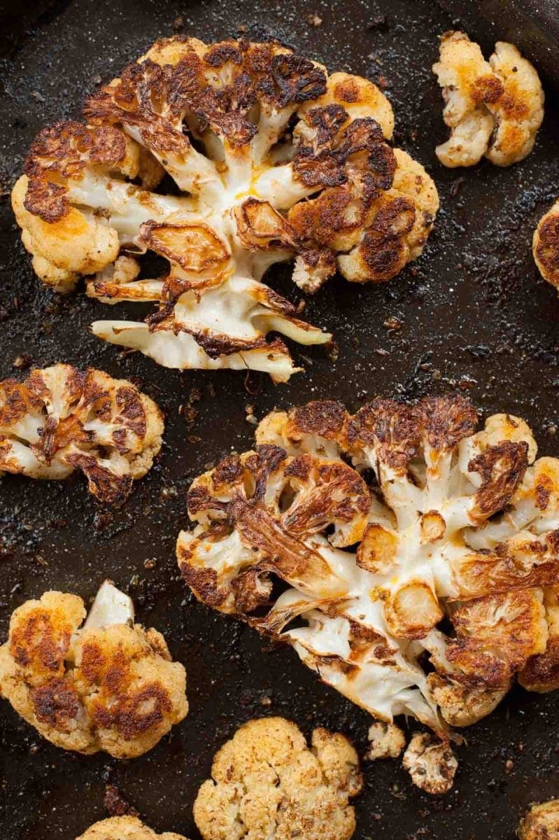 roasted cauliflower steaks on a baking tray