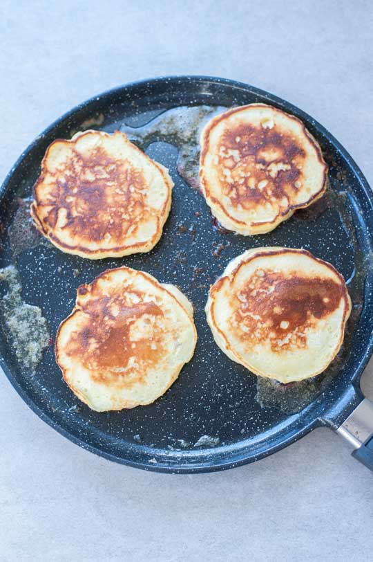 cooked lemon ricotta pancakes in a pan