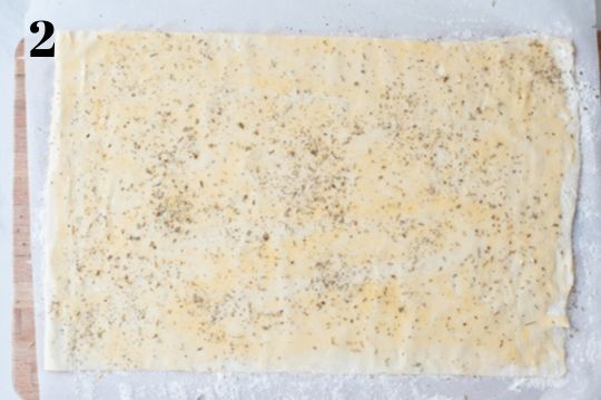 puff pastry sheet brushed with beaten egg and sprinkled with dried herbs