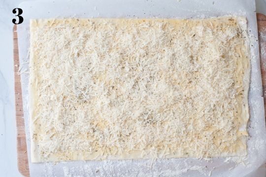 puff pastry sheet sprinkled with grated cheese