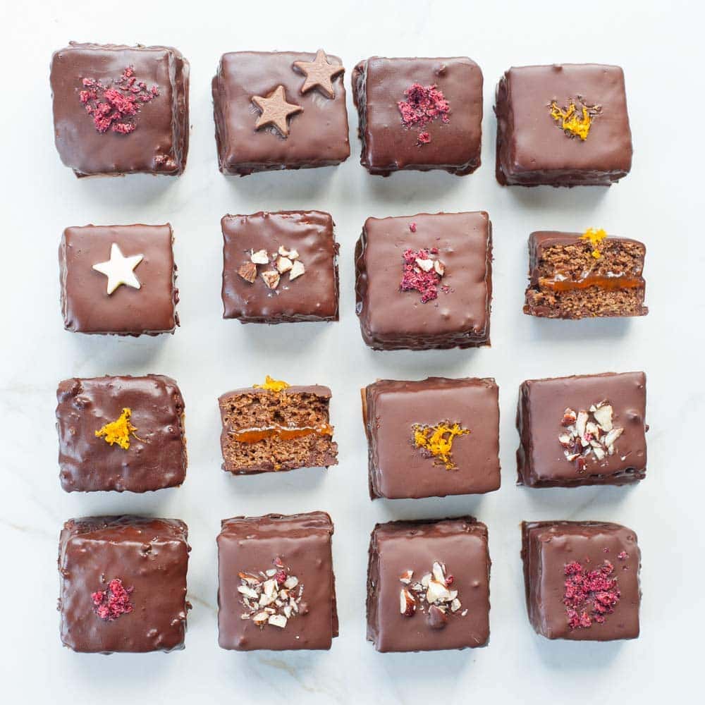 An overhead shot on gingerbread squares with plum jam and chocolate (Lebkuchen cookies).