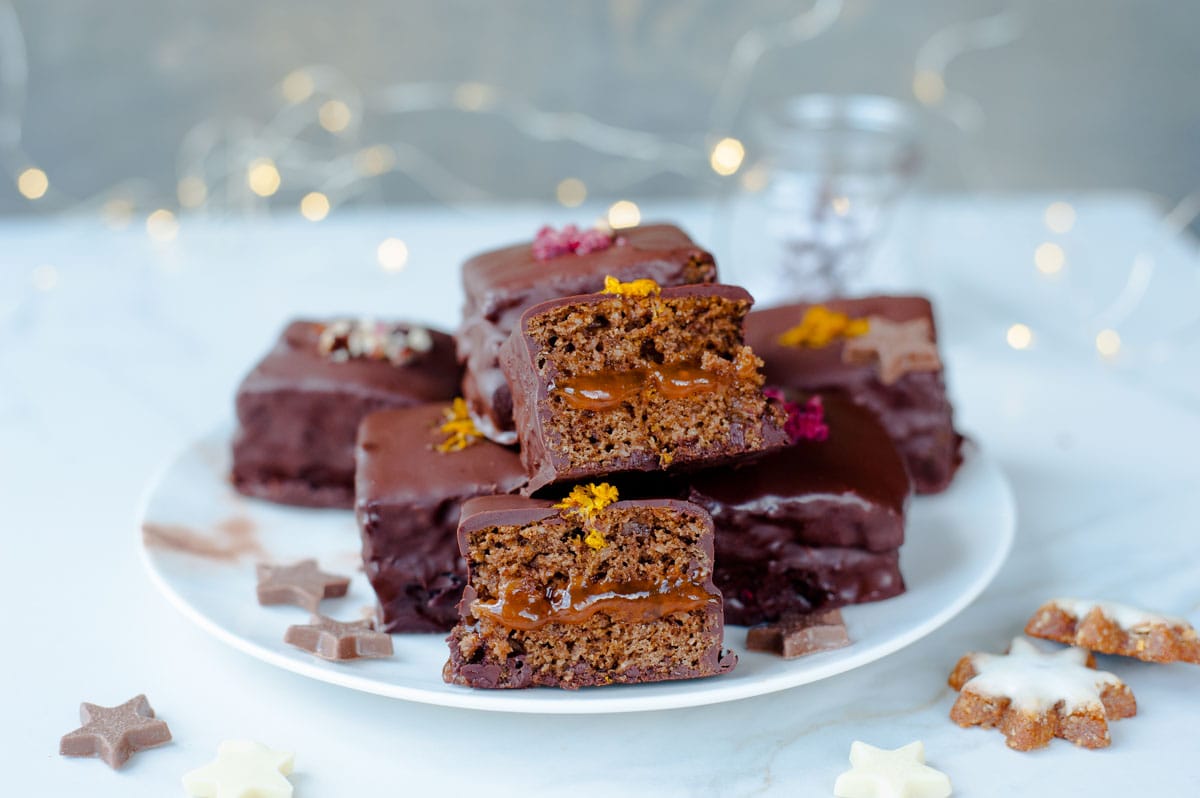 Gingerbread squares with plum jam and chocolate (Lebkuchen cookies) on a plate