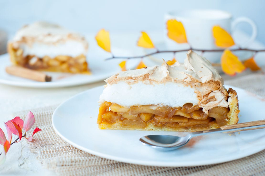 close up shot on a piece of Apple tart with meringue topping on a plate