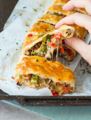 puff pastry strudel with vegetables and cheese on a piece of baking paper