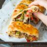 puff pastry strudel with vegetables and cheese on a piece of baking paper