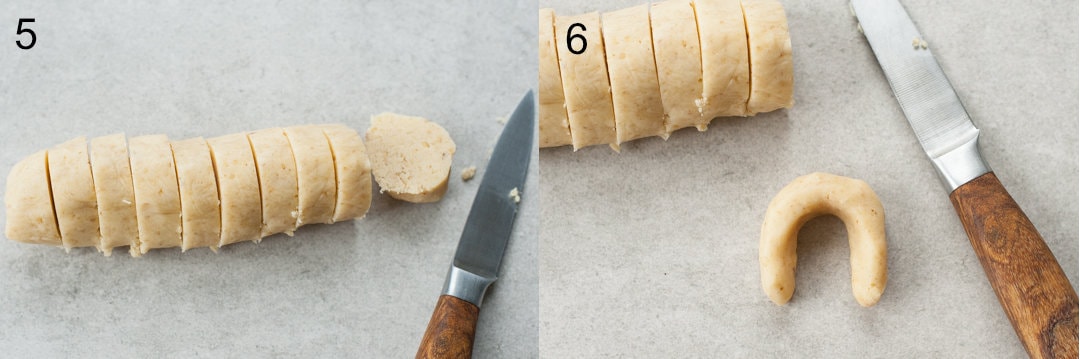 A log of dough cut into slices. Vanillekipferl cookie on a grey background.