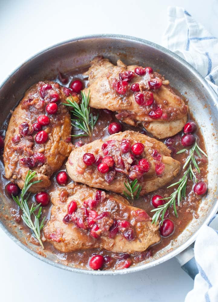 Cranberry balsamic chicken in a frying pan.