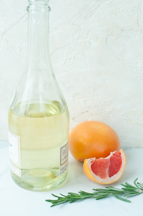 Ingredients needed to make grapefruit mimosa with rosemary.