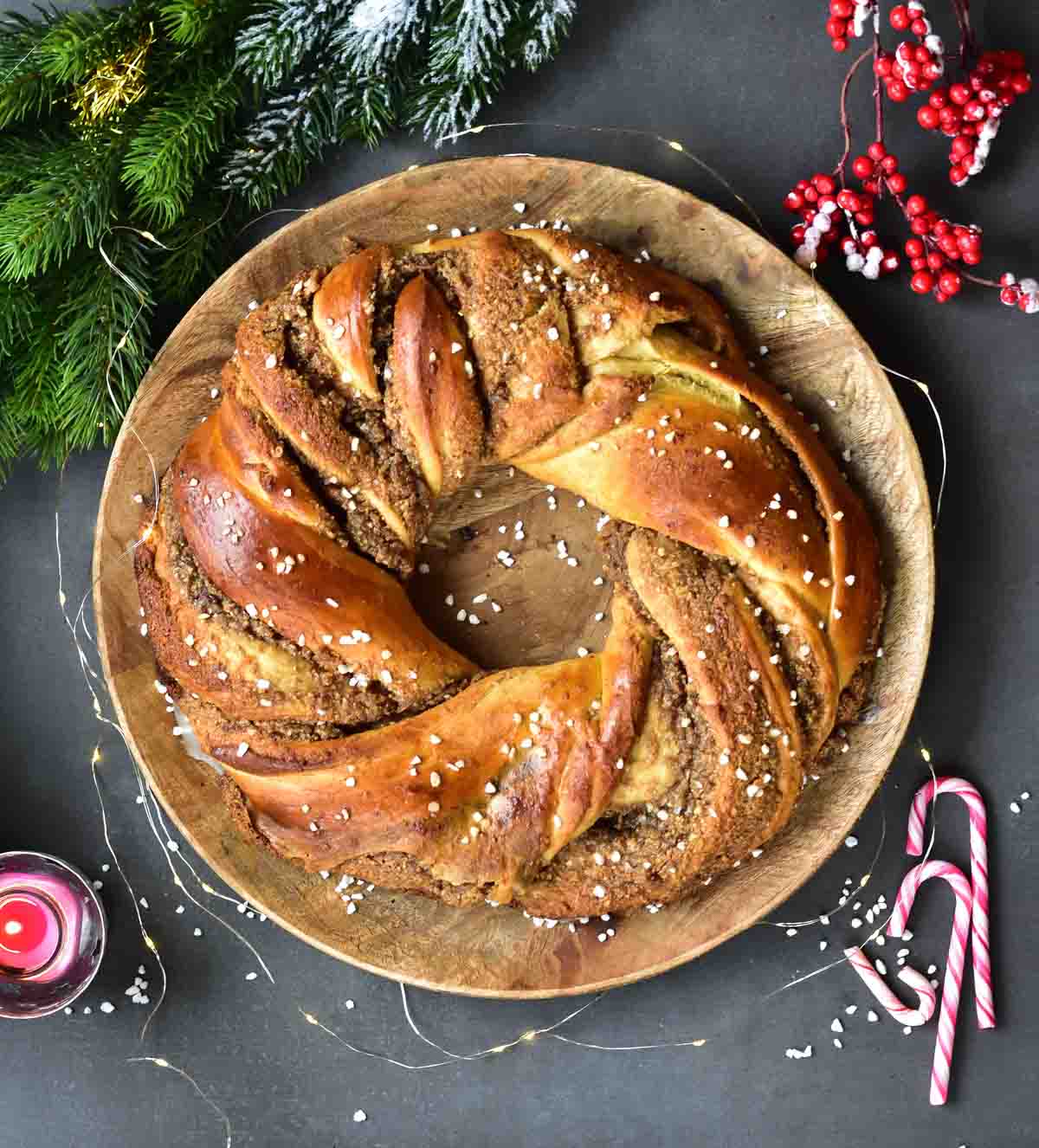 Nut roll with chocolate (babka wreath) on a wooden plate